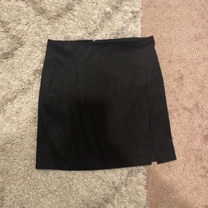 Size S black Forever 21 mini skirt with small slit in front. Never been worn NWT